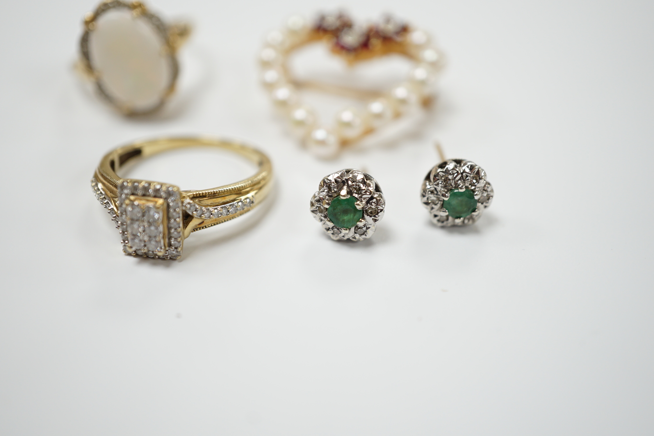 Two yellow metal and gem set rings, including diamond chip cluster and white opal and diamond chip cluster, together with a yellow metal, cultured pearl, ruby and diamond set open work heart shaped pendant brooch and a p
